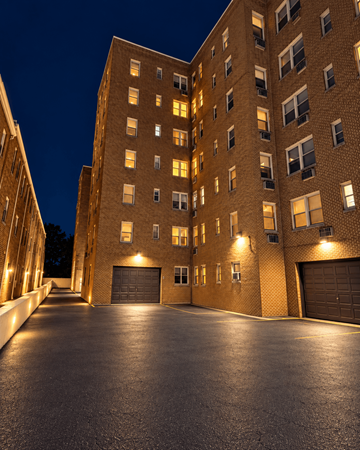 Wilmington apartment for rent - A large brick building with a driveway in front.