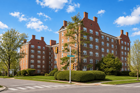 Bryn Mawr apartment for rent - A large red brick building with a green traffic light in front of it.