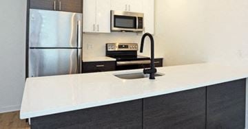 Philadelphia apartment for rent - a kitchen with a white counter top and a stainless steel refrigerator