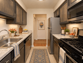 Philadelphia apartment for rent - A kitchen with a black stove top oven and a black refrigerator.