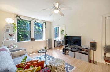 Philadelphia apartment for rent - A living room with a grey couch and a television.