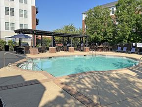 Wyomissing townhouse for rent - A large outdoor pool with a patio and umbrellas.