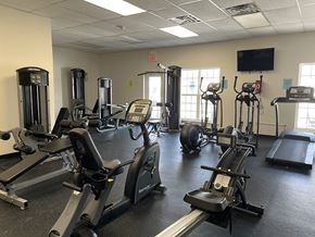 Hellam apartment for rent - A gym with treadmills, elliptical machines, and a television.