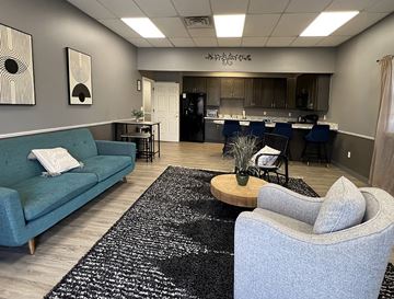 Hellam apartment for rent - A living room with a blue couch and a grey armchair.