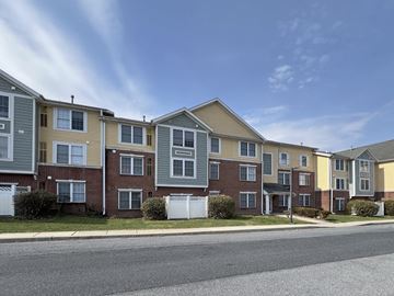 Camp Hill apartment for rent - A row of townhouses with a clear blue sky above them.