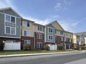 Camp Hill apartment for rent - A row of multi-story townhouses with different colored exteriors.