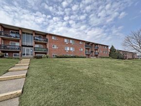 Camp Hill apartment for rent - A large grassy area in front of a brick apartment building.