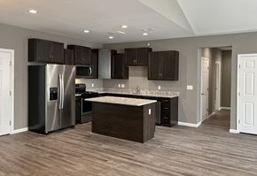 East Stroudsburg apartment for rent - a kitchen with stainless steel appliances and dark cabinets