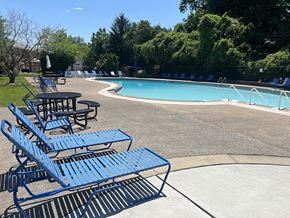 Lemoyne apartment for rent - A pool with blue lounge chairs and tables.