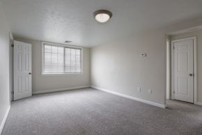 Horseheads apartment for rent - the living room of an empty house with a window and a door