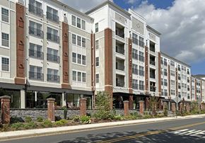 Wyomissing townhouse for rent - A row of apartment buildings with balconies and flower pots.
