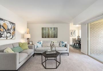 Harrisburg apartment for rent - A living room with a grey couch, a coffee table, and a painting on the wall.