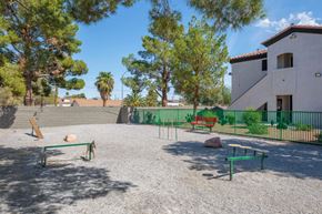 Las Vegas apartment for rent - A playground with a green fence and a bench.