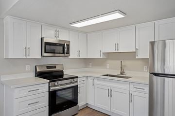 Las Vegas apartment for rent - A kitchen with white cabinets and appliances.