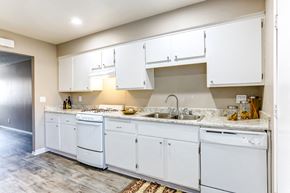 Reseda apartment for rent - a kitchen with white cabinets and a sink and a counter top