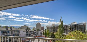 A balcony with a view of the city and mountains