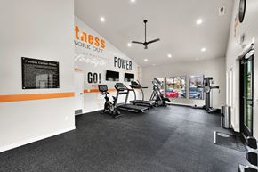 Roy townhouse for rent - A gym with a treadmill, exercise bike and other equipment.