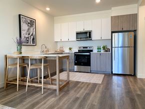Tracy apartment for rent - a kitchen with stainless steel appliances and a bar with stools