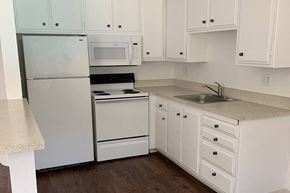Davis apartment for rent - Renovated kitchen with white cabinets and appliances