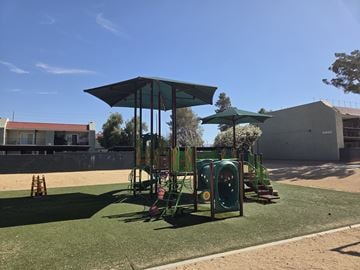 Lancaster apartment for rent - A playground with a green canopy and a slide.