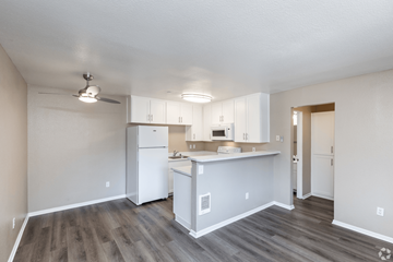 San Rafael apartment for rent - A kitchen with white cabinets and a white refrigerator.