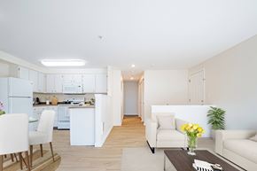 Troutdale apartment for rent - A modern kitchen with white appliances and a dining area with a white chair and table at Troutdale Terrace, Troutdale