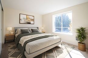 Troutdale apartment for rent - A bedroom with a large bed and a potted plant at Troutdale Terrace, OR, 97060
