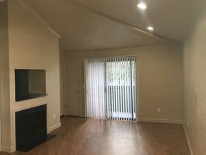 Stockton apartment for rent - Living room with patio and fireplace