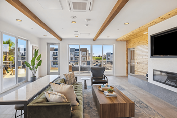 A modern living room with a fireplace and a view of the city.