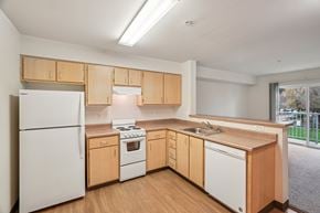 Vancouver apartment for rent - A kitchen with wooden cabinets and white appliances.at Vintage at Vancouver, Vancouver, 98662