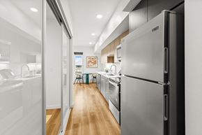 Shoreline apartment for rent - A modern kitchen with a refrigerator on the right at Two 10 by Vintage, Shoreline, WA 98133