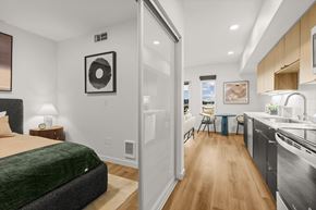 Shoreline apartment for rent - A bedroom with a bed, a nightstand with a lamp, and a picture on the wall at Two 10 by Vintage, Shoreline, Washington