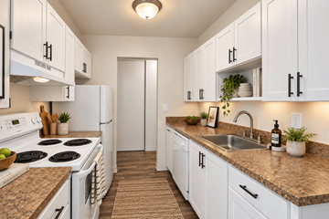 Seattle apartment for rent - A kitchen with white cabinets and a granite countertop.