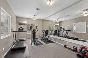 Vancouver townhouse for rent - A well-equipped home gym with a treadmill, exercise bike, and other fitness equipment.
