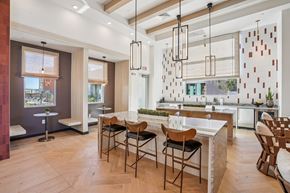 Casa Grande apartment for rent - A modern kitchen with a dining table and chairs.at Cottonwood Ranch, Casa Grande, AZ 85122