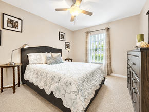 Orlando apartment for rent - A bedroom with a large bed and a ceiling fan.