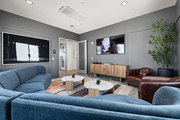 Modesto apartment for rent - A modern living room with a grey couch and a wooden coffee table.