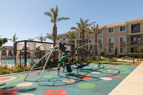 Antioch apartment for rent - children playing on a playground in front of an apartment building