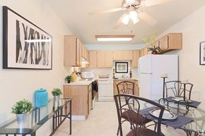 Sacramento triplex for rent - Ashford park kitchen and dining area with ceiling fan and light colored cabinets