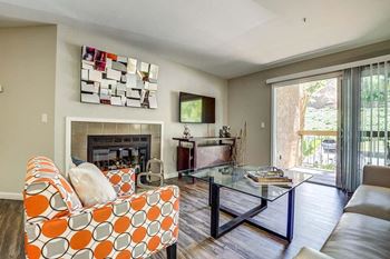 A living room with a fireplace and a television.