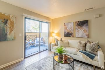 Sacramento apartment for rent - A living room with a white couch and a painting on the wall.