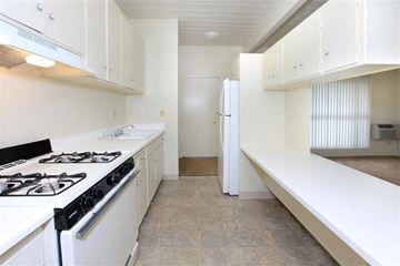 La Mesa apartment for rent - A white kitchen with a black stove top.