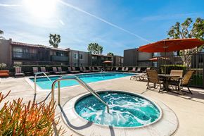Cypress apartment for rent - our apartments have a resort style pool with chairs and umbrellas at CASA GRANDE APARTMENT HOMES, Cypress, 90630