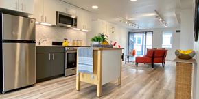 Oakland apartment for rent - A modern kitchen with a refrigerator, oven, and microwave.