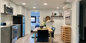 Oakland apartment for rent - A kitchen with a table and chairs in the middle of it.