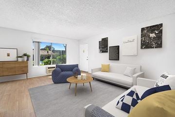 Spring Valley apartment for rent - A living room with a blue chair and a white couch.