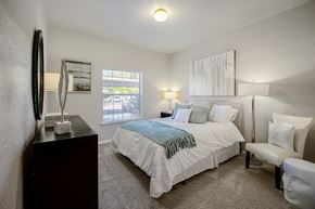 Rancho Cordova apartment for rent - a bedroom with a bed and a chair in a room