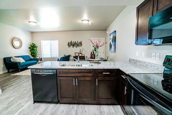 Full kitchen with granite countertops and stainless steel appliances at the preserve at great neck