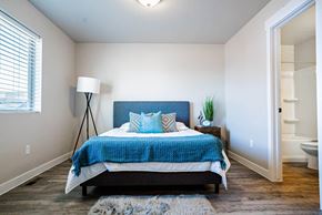 Roy townhouse for rent - a bedroom with a bed and a closet at Arcadia Townhomes, Roy, UT