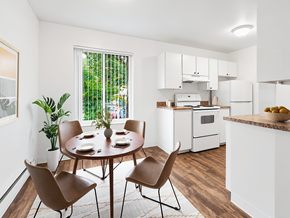 Seattle apartment for rent - A dining room with a table set for four and chairs around it.